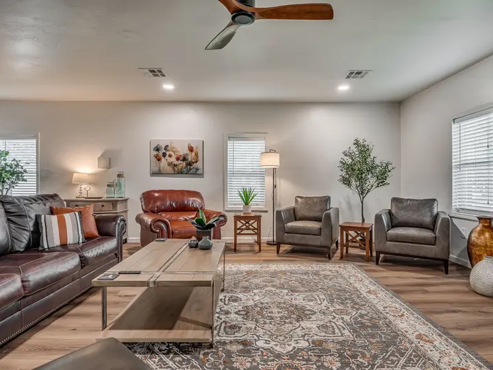 Living room with a leather sofa, red leather recliner and armchairs
