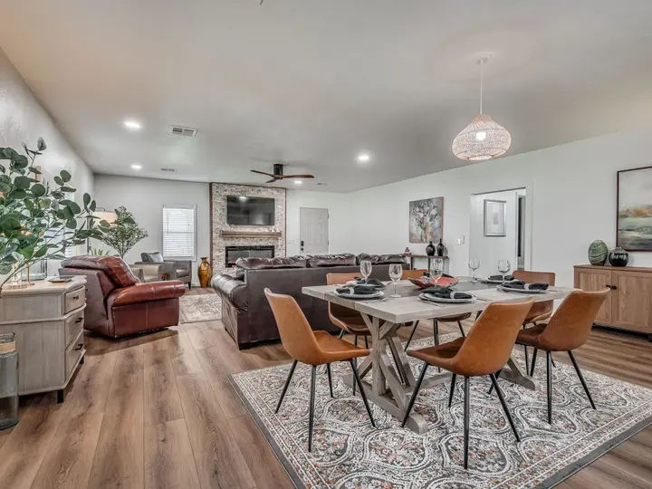 Dining table for six with leather chairs, open to the living room